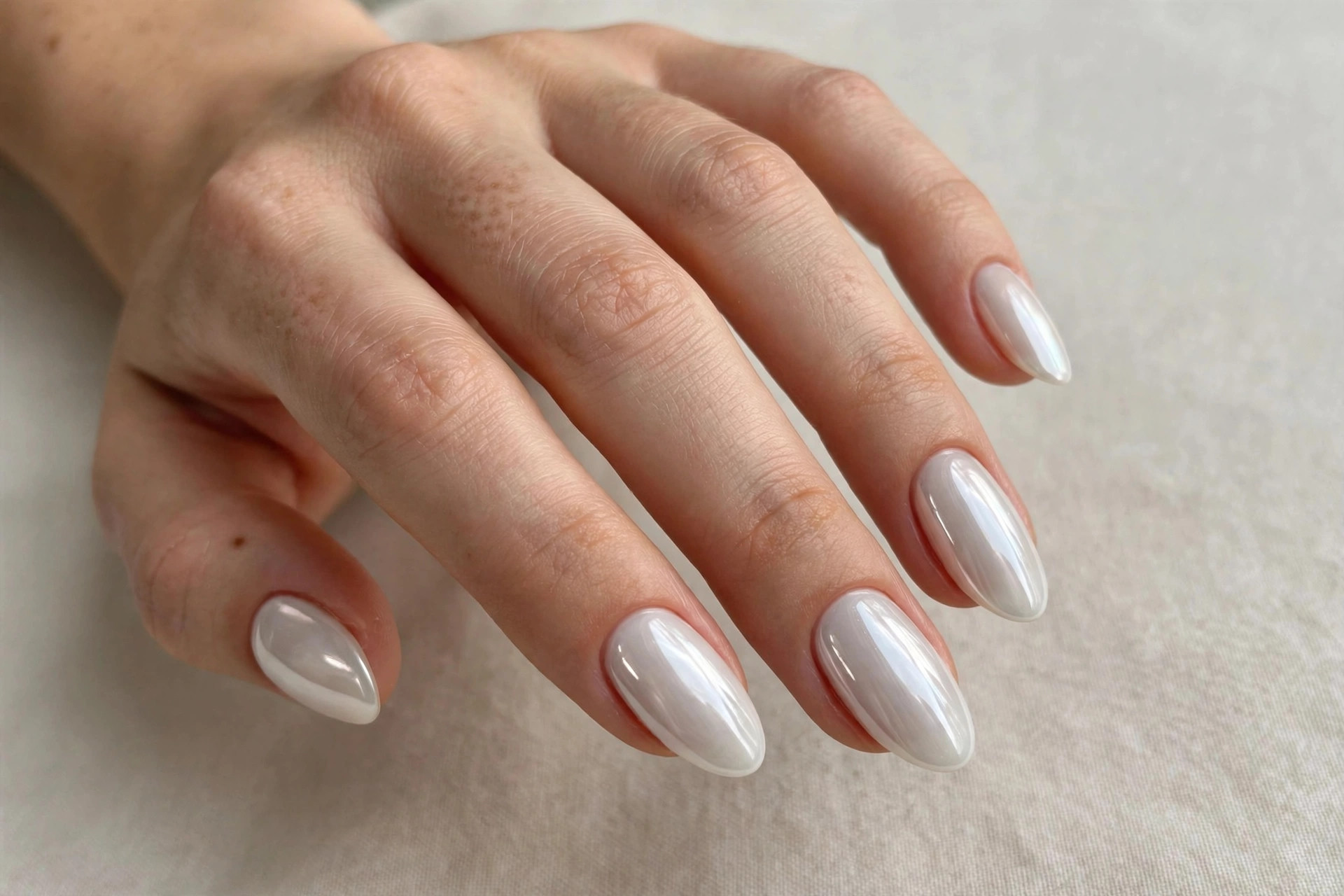 White glazed donut chrome nails with a pearly reflective shine