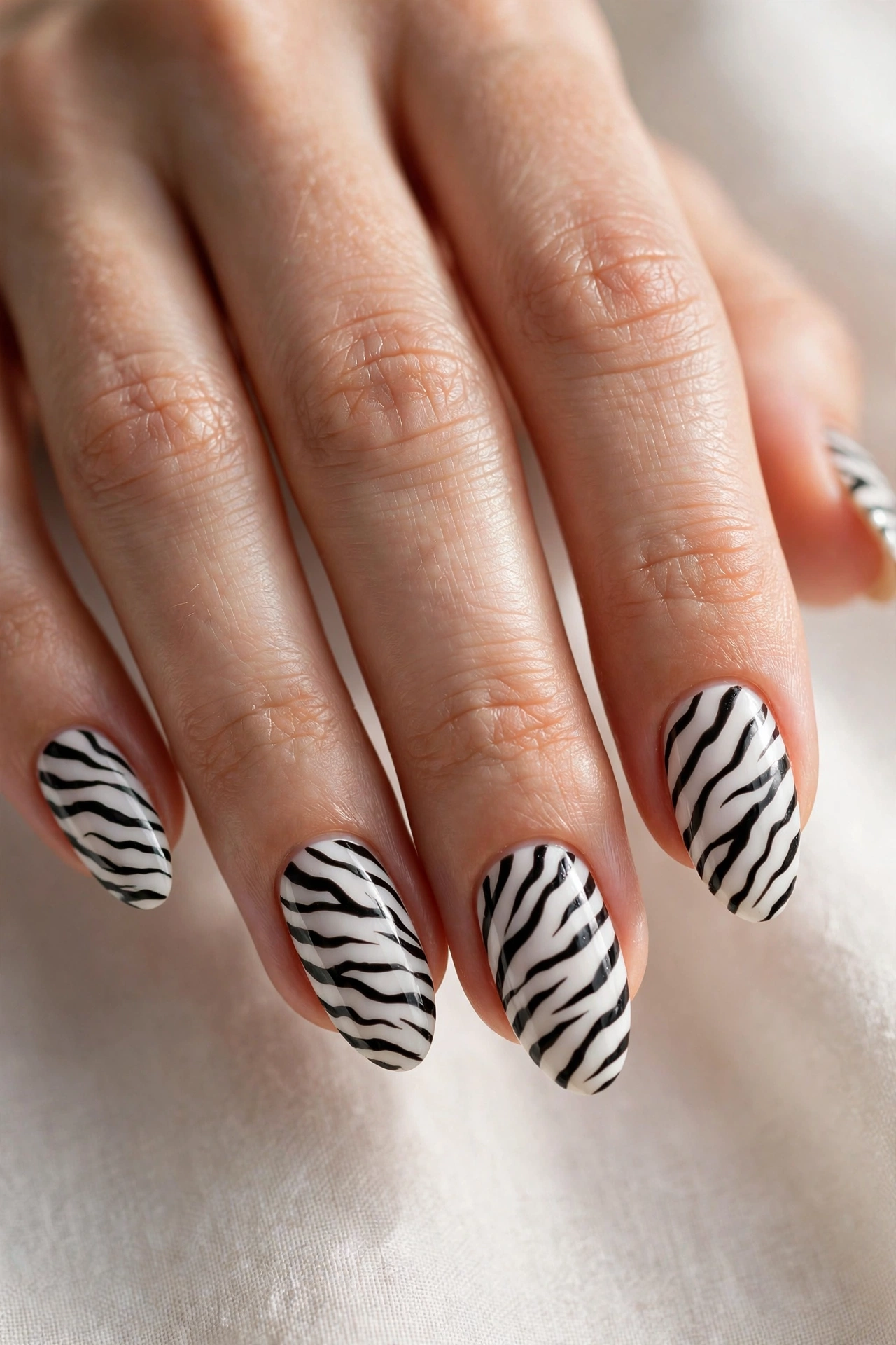 Classic black and white zebra stripe nail art on almond nails