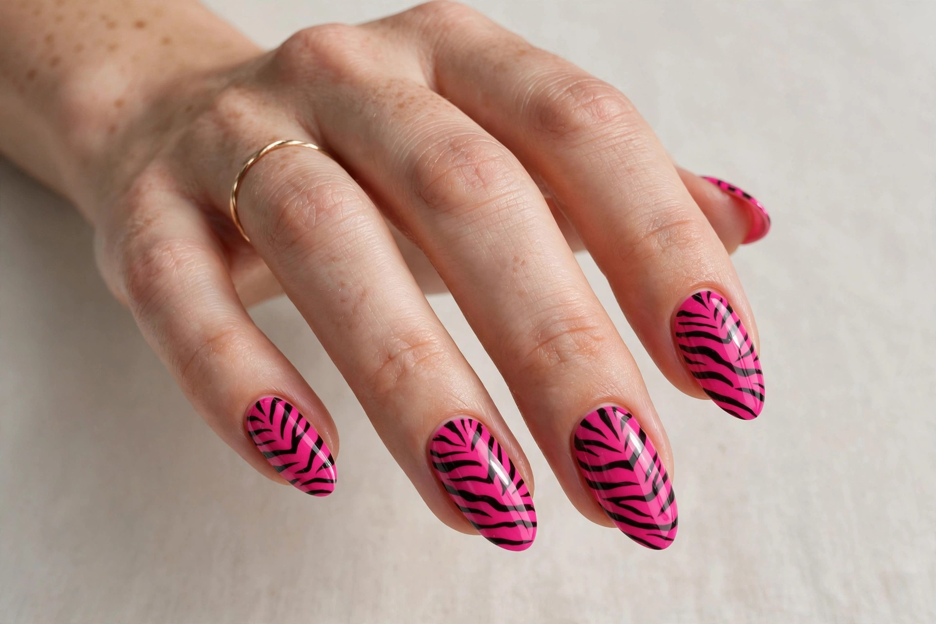Hot pink zebra print manicure with black stripes
