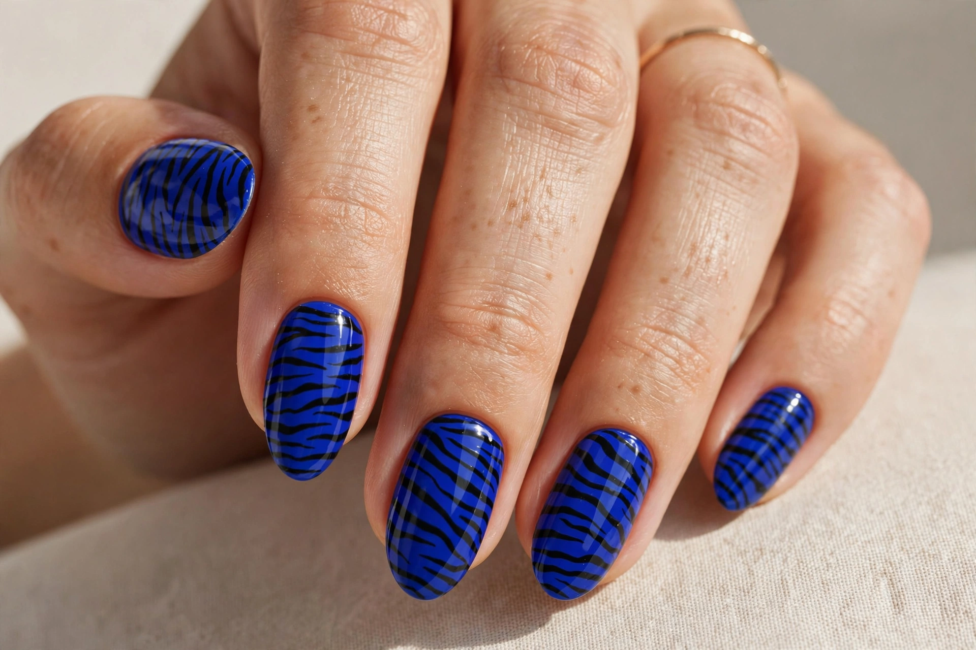 Royal blue zebra print manicure with black stripes