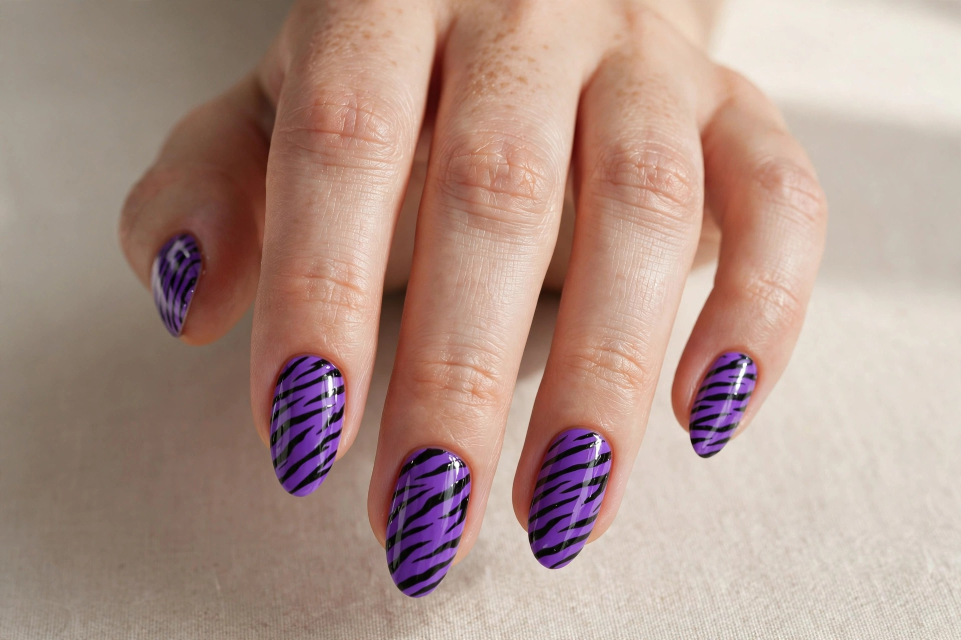 Vibrant purple zebra print manicure
